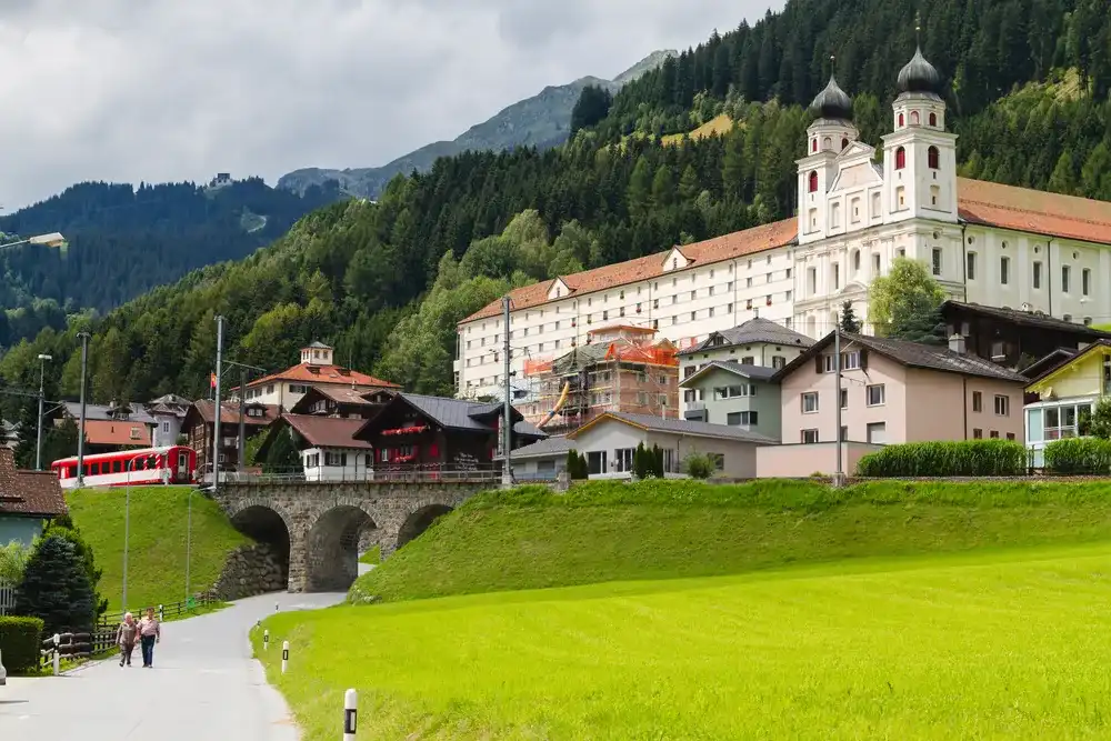 DISENTIS -MUSTER, SWITZERLAND - AUGUST 10: Benedictine monastery in the Swiss Alps, Disentis -Muster, Switzerland on August 10, 2014. The monastery was built between 1696 and 1712. DISENTIS -MUSTER, SWITZERLAND - AUGUST 10: Benedictine monastery in the Swiss Alps, Disentis -Muster, Switzerland on August 10, 2014. The monastery was built between 1696 and 1712.