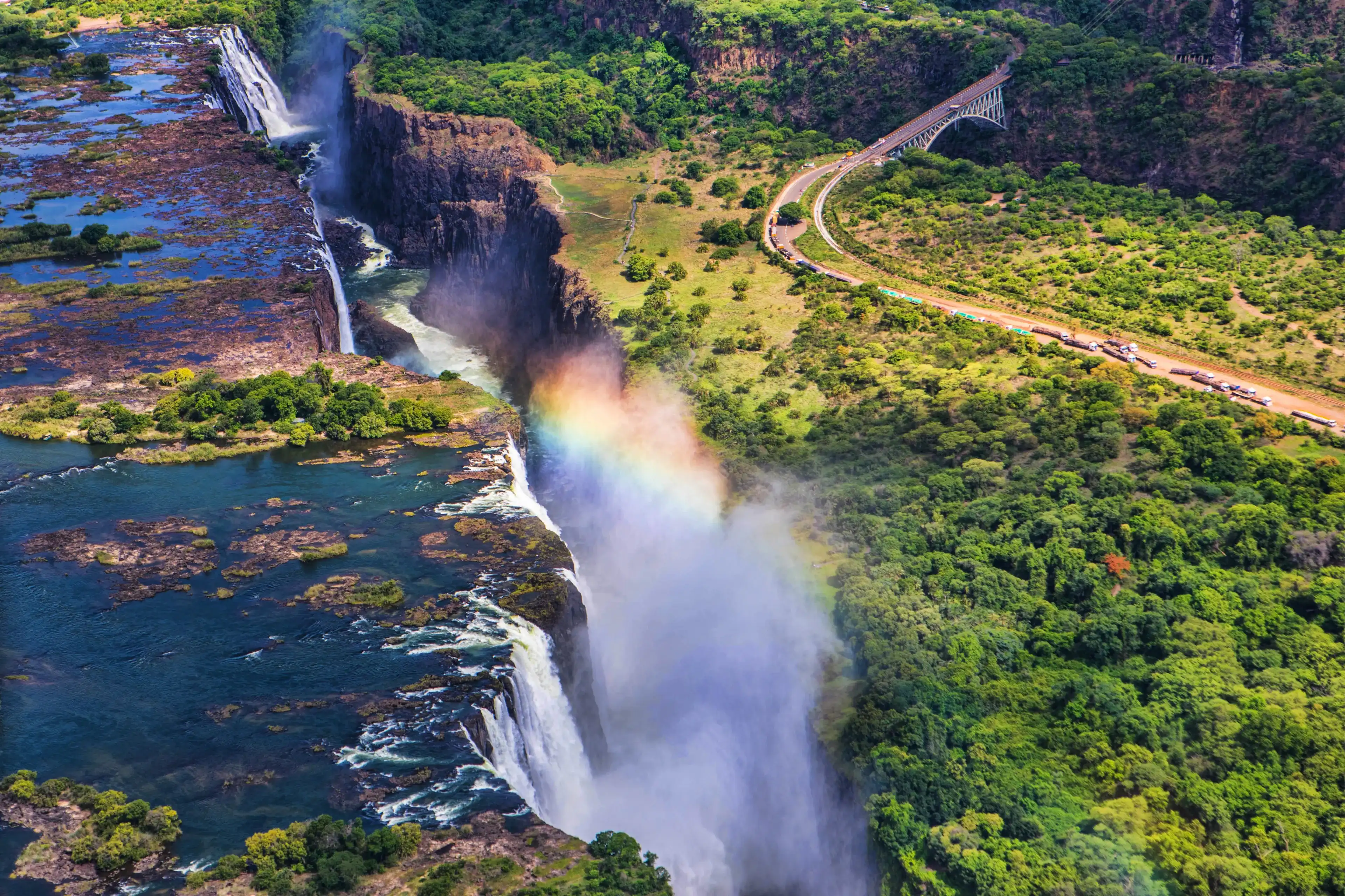 Rainbow over Victoria Falls in Zimbabwe, sunny day in Africa Rainbow over Victoria Falls in Zimbabwe, sunny day in Africa