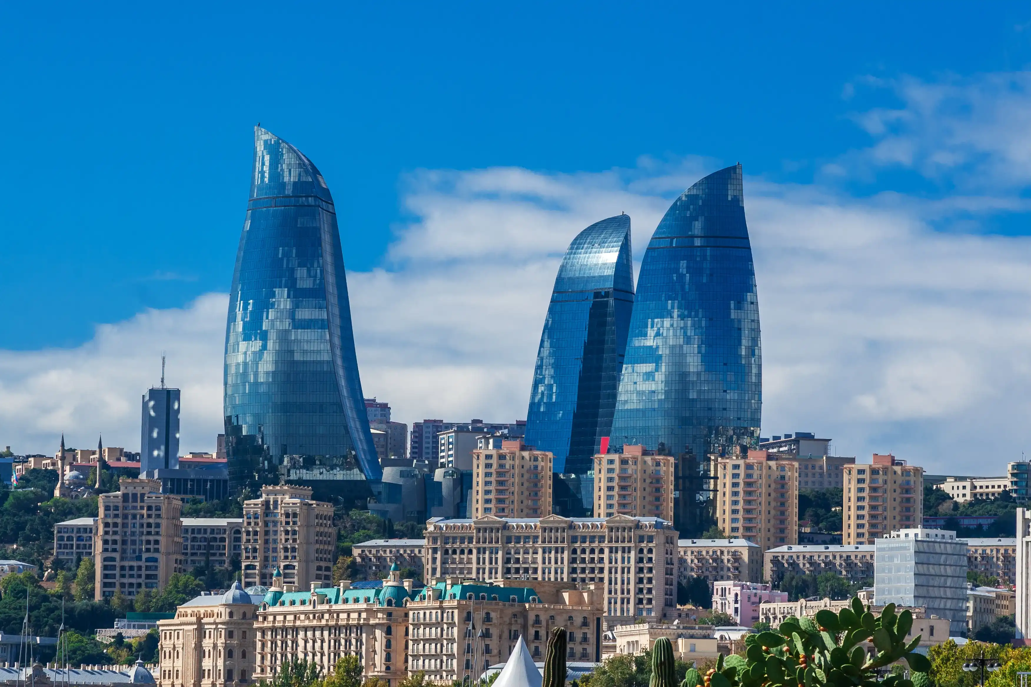 Baku, Azerbaijan - October 2, 2016: Flame towers in the cityscape. Panoramic view of Baku - the capital of Azerbaijan located by the Caspian See shore. Baku, Azerbaijan - October 2, 2016: Flame towers in the cityscape. Panoramic view of Baku - the capital of Azerbaijan located by the Caspian See shore.