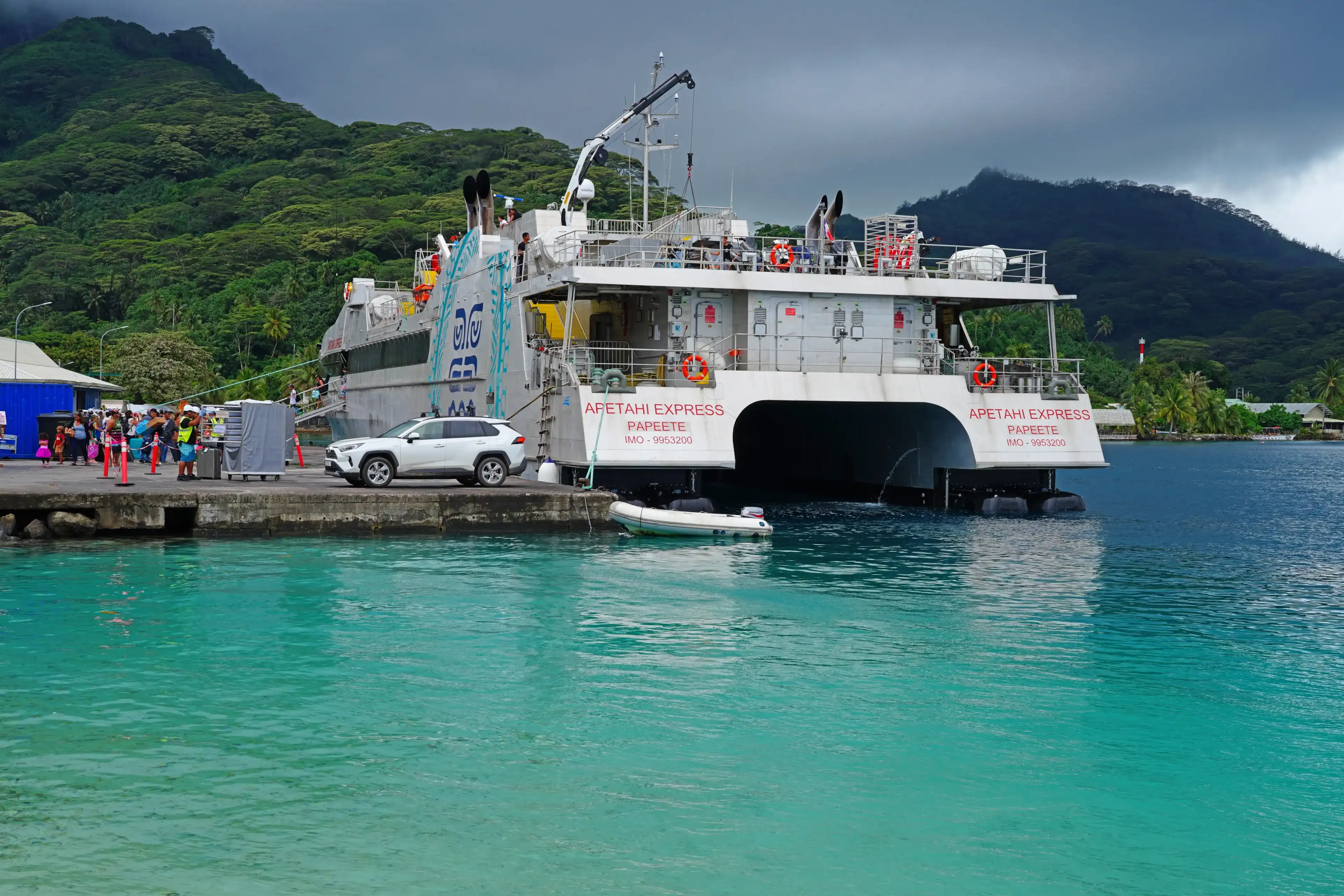 HUAHINE, FRENCH POLYNESIA – 5 DEC 2023 – View of the Apetahi Express, a ferry connecting islands in French Polynesia, in the Fare harbor, Huahine, Society Islands. HUAHINE, FRENCH POLYNESIA – 5 DEC 2023 – View of the Apetahi Express, a ferry connecting islands in French Polynesia, in the Fare harbor, Huahine, Society Islands.