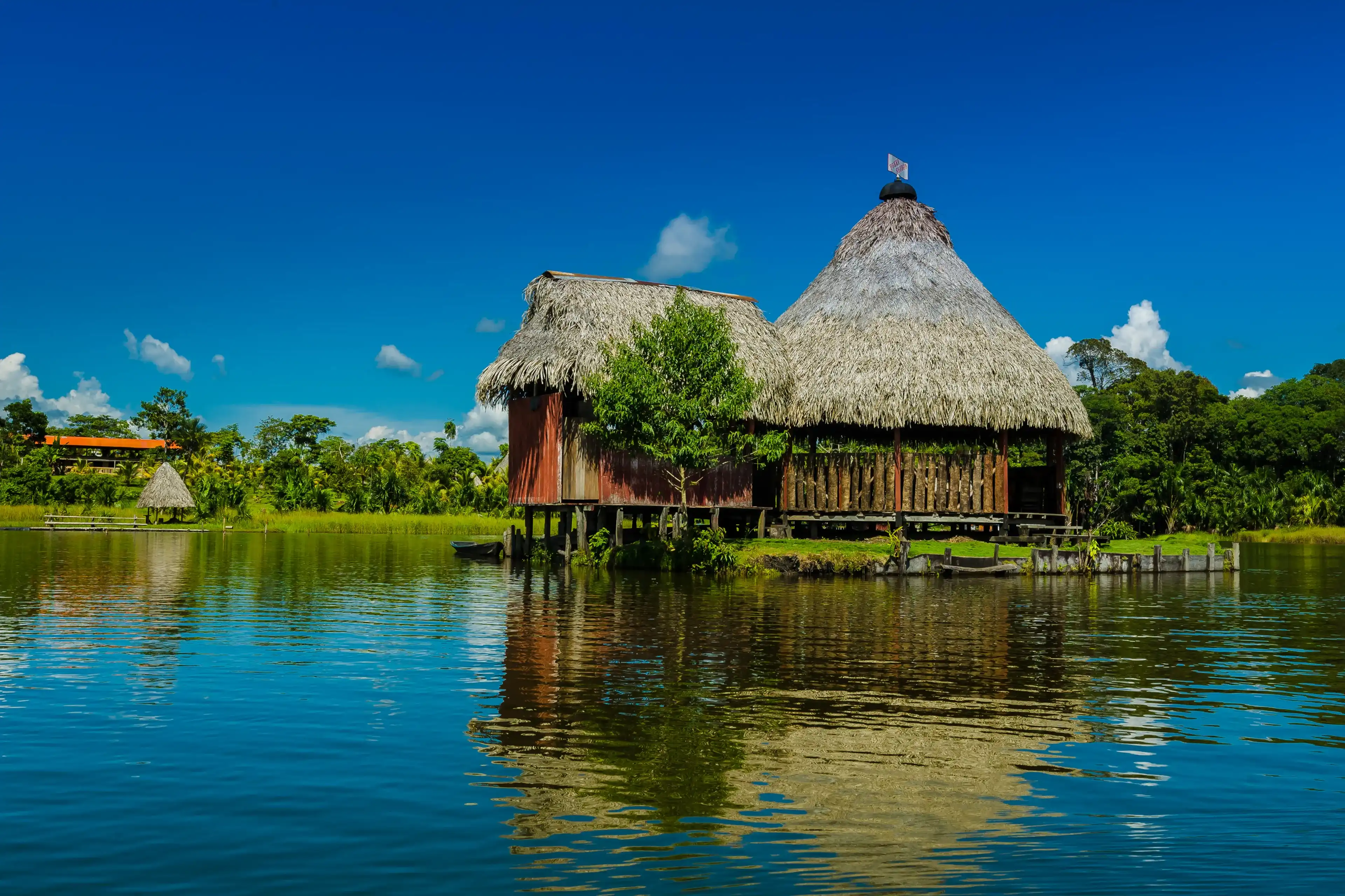 Wooden and straw house built on the lake in the Peruvian jungle Wooden and straw house built on the lake in the Peruvian jungle