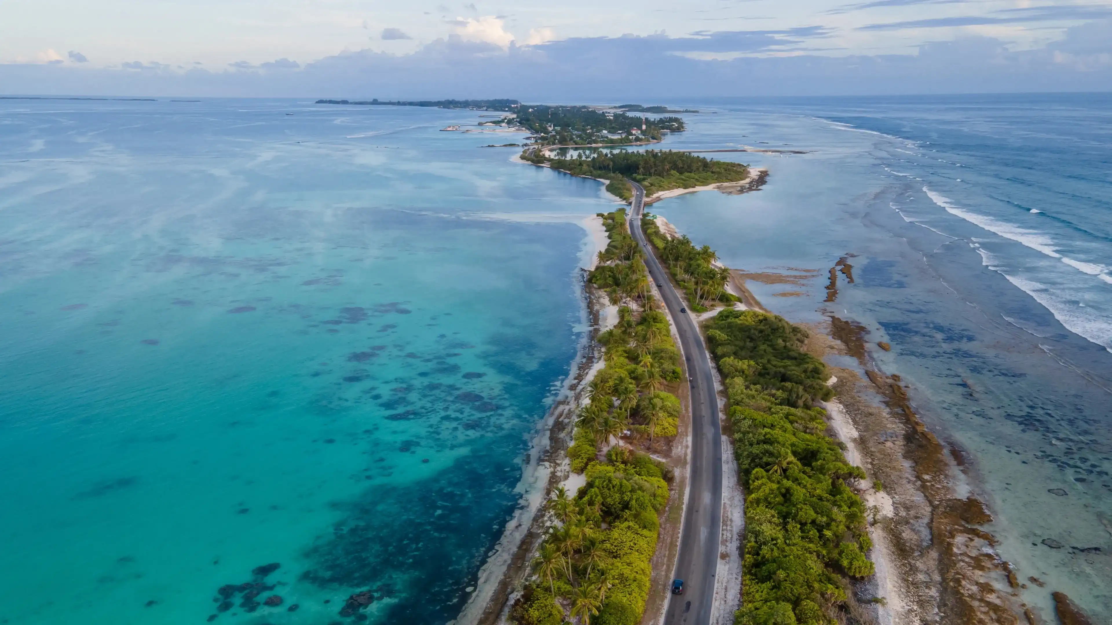 Aerial view of tropical beach landscape and local road at addu city, the southernmost atoll of Maldives in Indian ocean. Maldives tourism and summer vacation concepts Aerial view of tropical beach landscape and local road at addu city, the southernmost atoll of Maldives in Indian ocean. Maldives tourism and summer vacation concepts