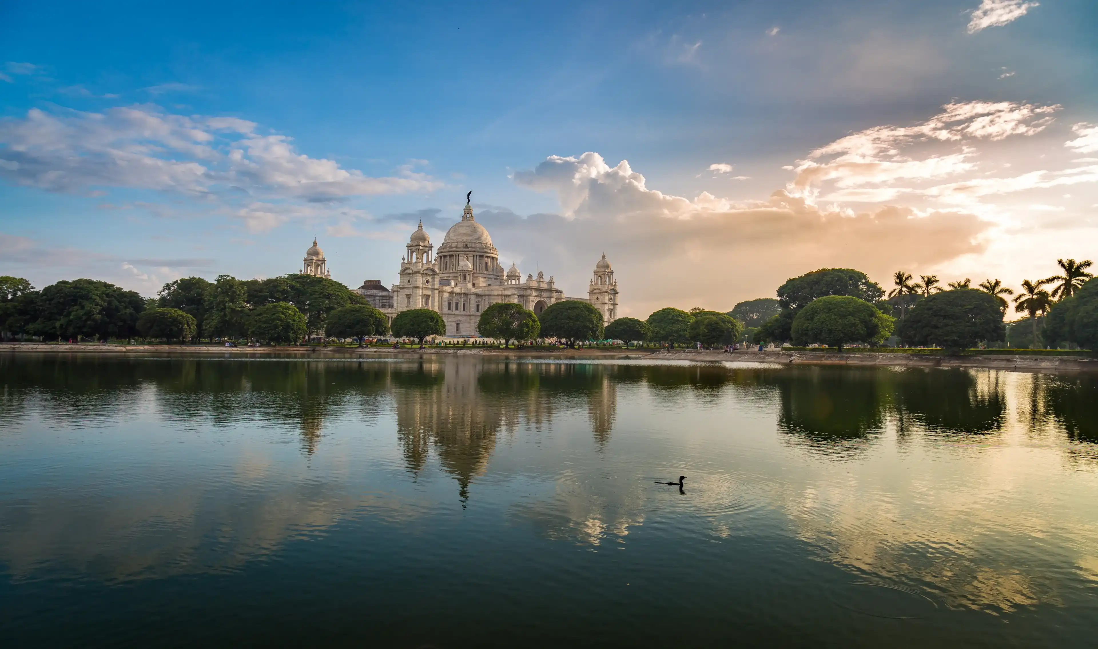 Victoria Memorial Kolkata at sunset with vibrant moody sky and mirror refections in water. Victoria Memorial is a monument and museum built in the memory of Queen Victoria in 1921 at Kolkata, India. Victoria Memorial Kolkata at sunset with vibrant moody sky and mirror refections in water. Victoria Memorial is a monument and museum built in the memory of Queen Victoria in 1921 at Kolkata, India.