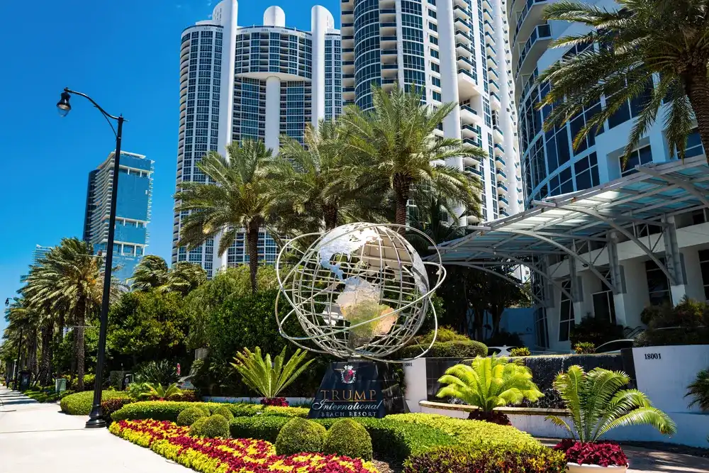 Sunny Isles, Florida, USA - May, 2020: Trump International Beach Resort main entrance to resort with 347 units of sales and rentals on Collins Avenue in Sunny Isles Beach outside Miami FL Sunny Isles, Florida, USA - May, 2020: Trump International Beach Resort main entrance to resort with 347 units of sales and rentals on Collins Avenue in Sunny Isles Beach outside Miami FL