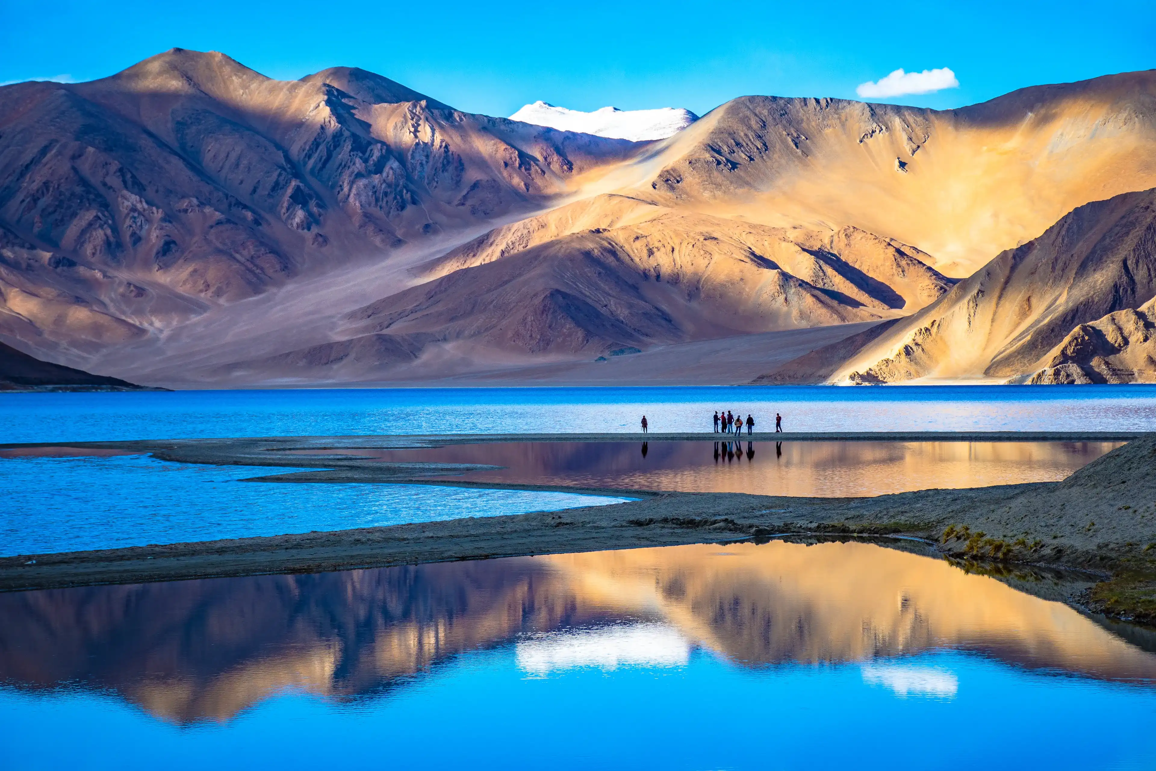 Leh, Ladakh, India-June 8 2017: Landscape with reflections of the mountains on the lake named Pagong Tso, situated on the border with India and China. Leh, Ladakh, India-June 8 2017: Landscape with reflections of the mountains on the lake named Pagong Tso, situated on the border with India and China.
