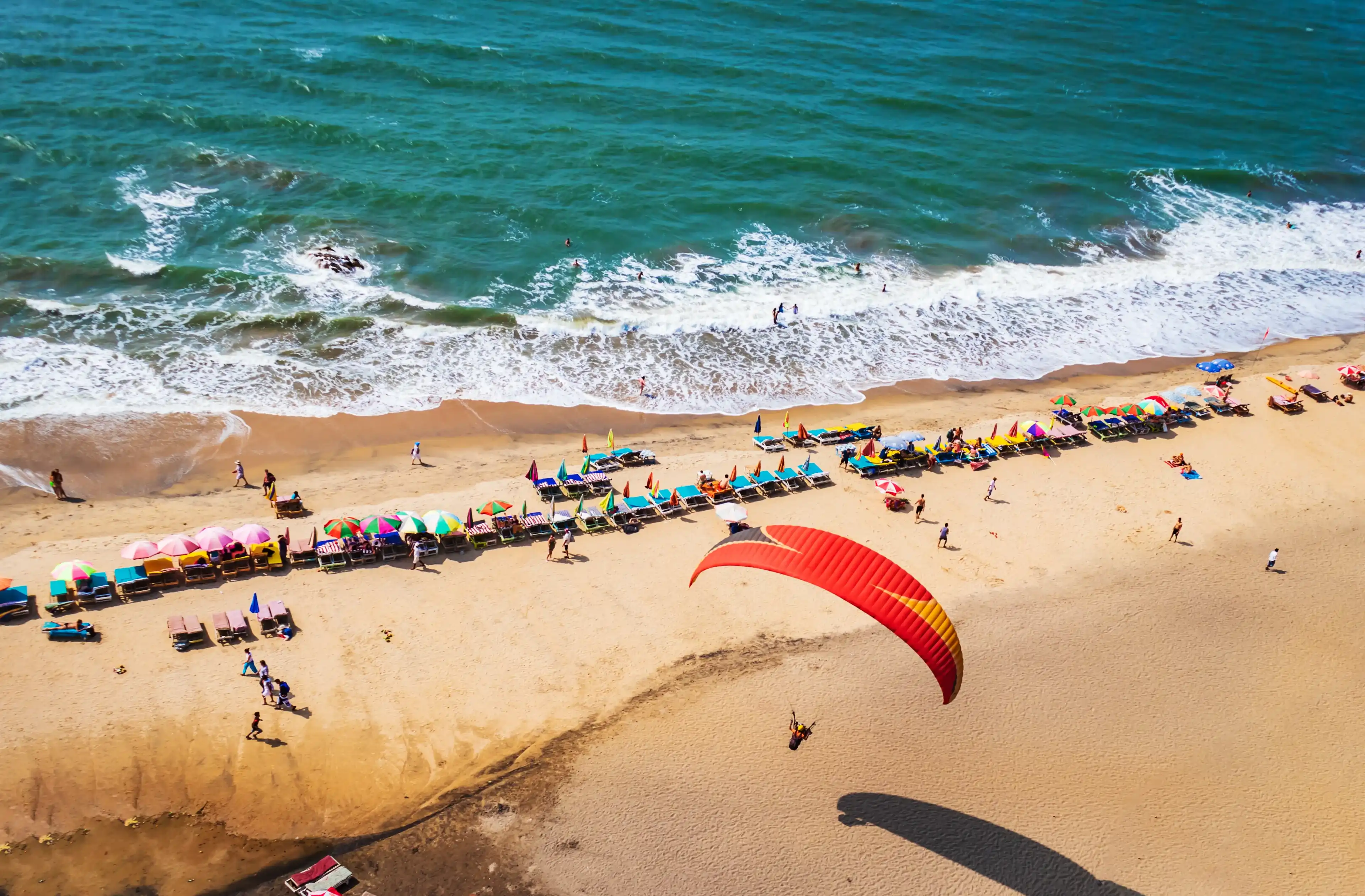 top view of beach in Goa India vagator beach. people taking sunbath on the beach on shacks top view of beach in Goa India vagator beach. people taking sunbath on the beach on shacks