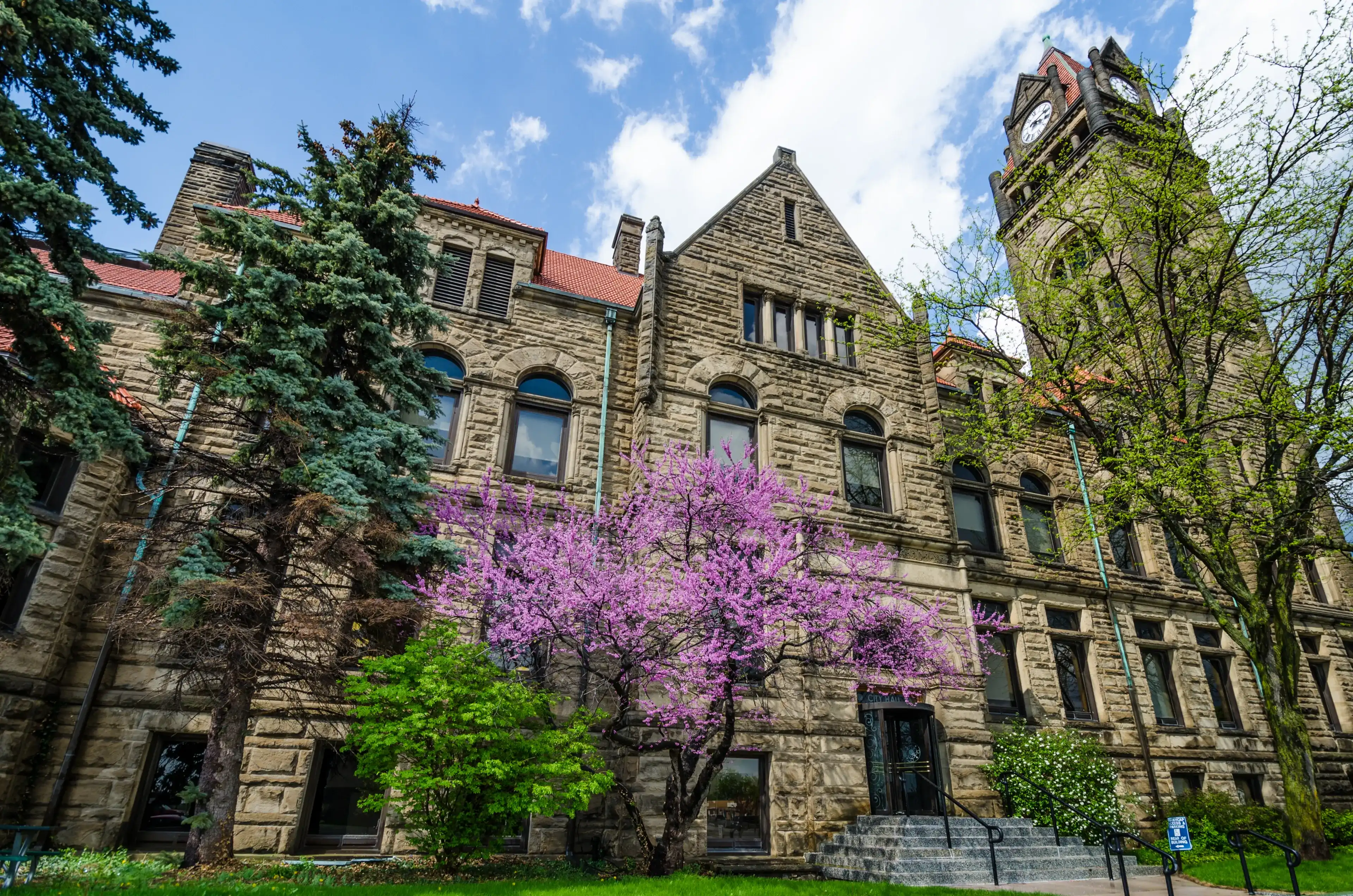 BAY CITY, MICHIGAN – MAY 21, 2014: The historic City Hall is an excellent example of municipal architecture in the American Romanesque style. The building was constructed from 1894 to 1897. BAY CITY, MICHIGAN – MAY 21, 2014: The historic City Hall is an excellent example of municipal architecture in the American Romanesque style. The building was constructed from 1894 to 1897.