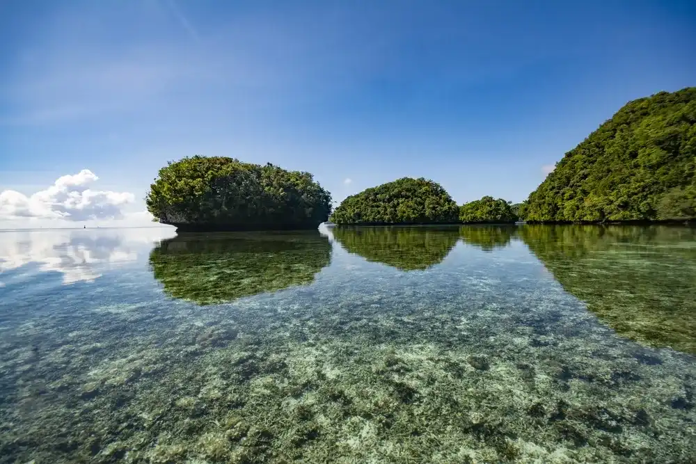 Sky, reflection, small islands and Ocean, Rock Islands Southern Lagoon, World heritage site in Koror state, Palau Sky, reflection, small islands and Ocean, Rock Islands Southern Lagoon, World heritage site in Koror state, Palau