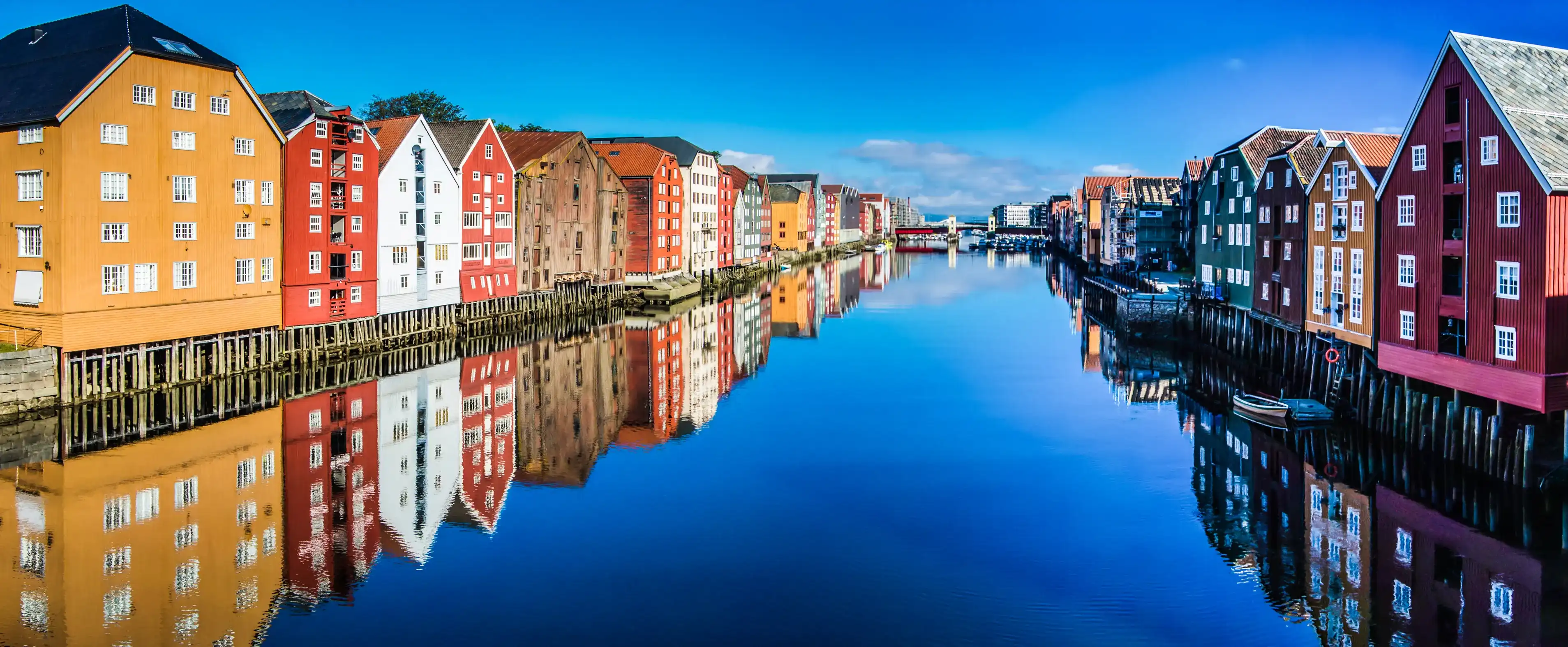 Panoramic view from bridge to famous wooden colored houses in Trondheim city, Norway - architecture background Panoramic view from bridge to famous wooden colored houses in Trondheim city, Norway - architecture background