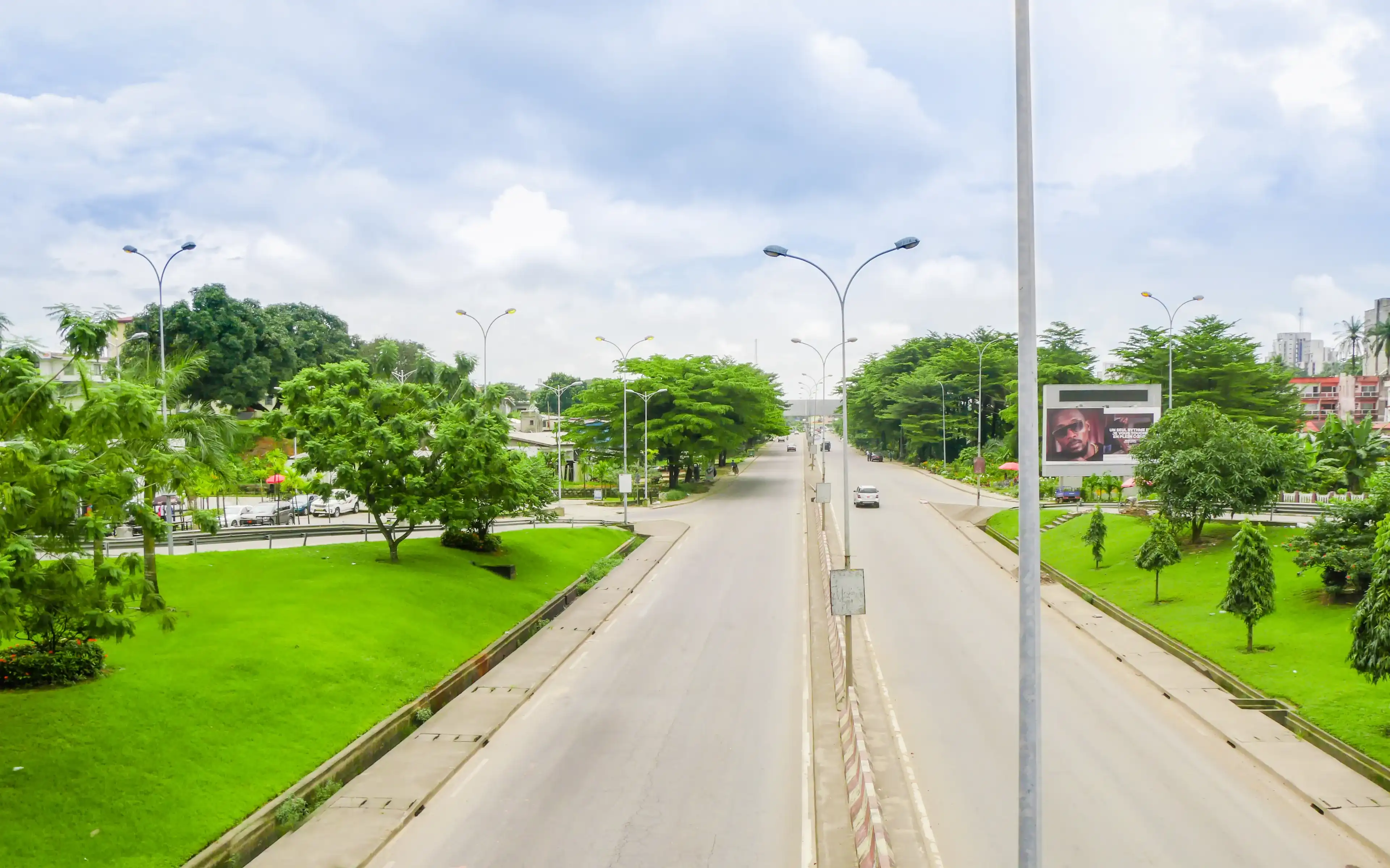 Douala, Littoral/Cameroon - 11/12/2019 : Beautiful view on the main boulevard leading to the Douala port and Bonanjo, the administrative district of the city of Douala in Cameroon. Douala, Littoral/Cameroon - 11/12/2019 : Beautiful view on the main boulevard leading to the Douala port and Bonanjo, the administrative district of the city of Douala in Cameroon.