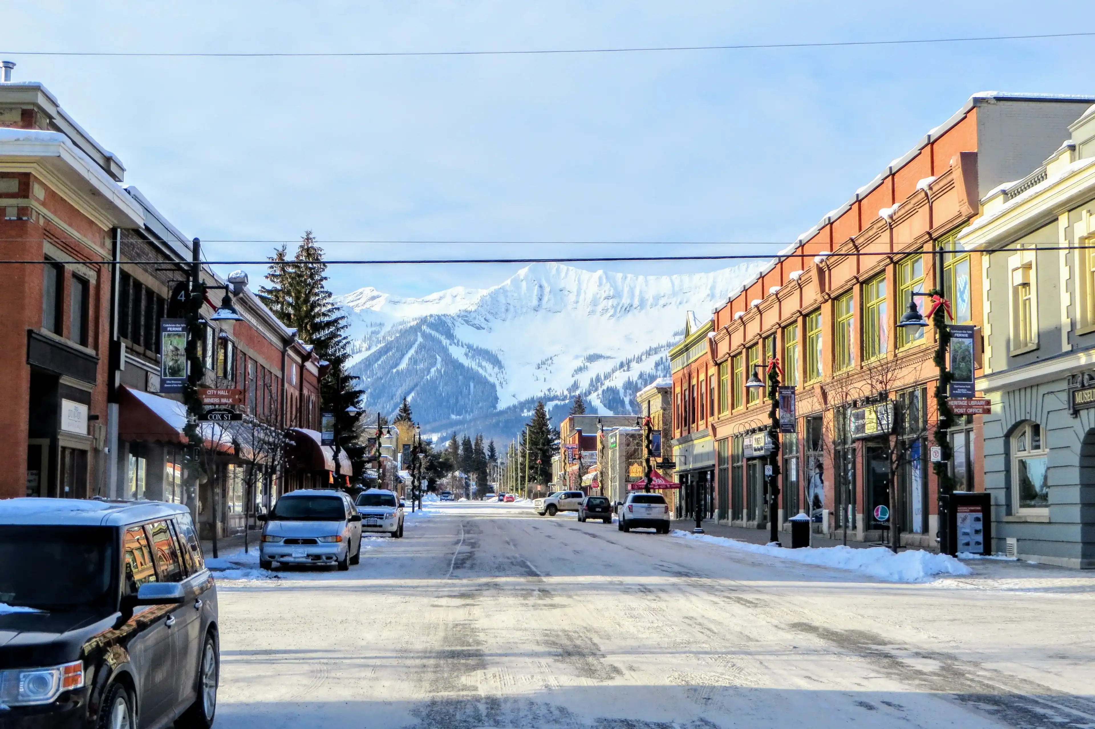 Fernie, British Columbia, Canada - February 24th, 2019: A view down the streets of downtown Fernie, British Columbia, Canada on a sunny morning during the winter. A popular ski town in the Rockies. Fernie, British Columbia, Canada - February 24th, 2019: A view down the streets of downtown Fernie, British Columbia, Canada on a sunny morning during the winter. A popular ski town in the Rockies.