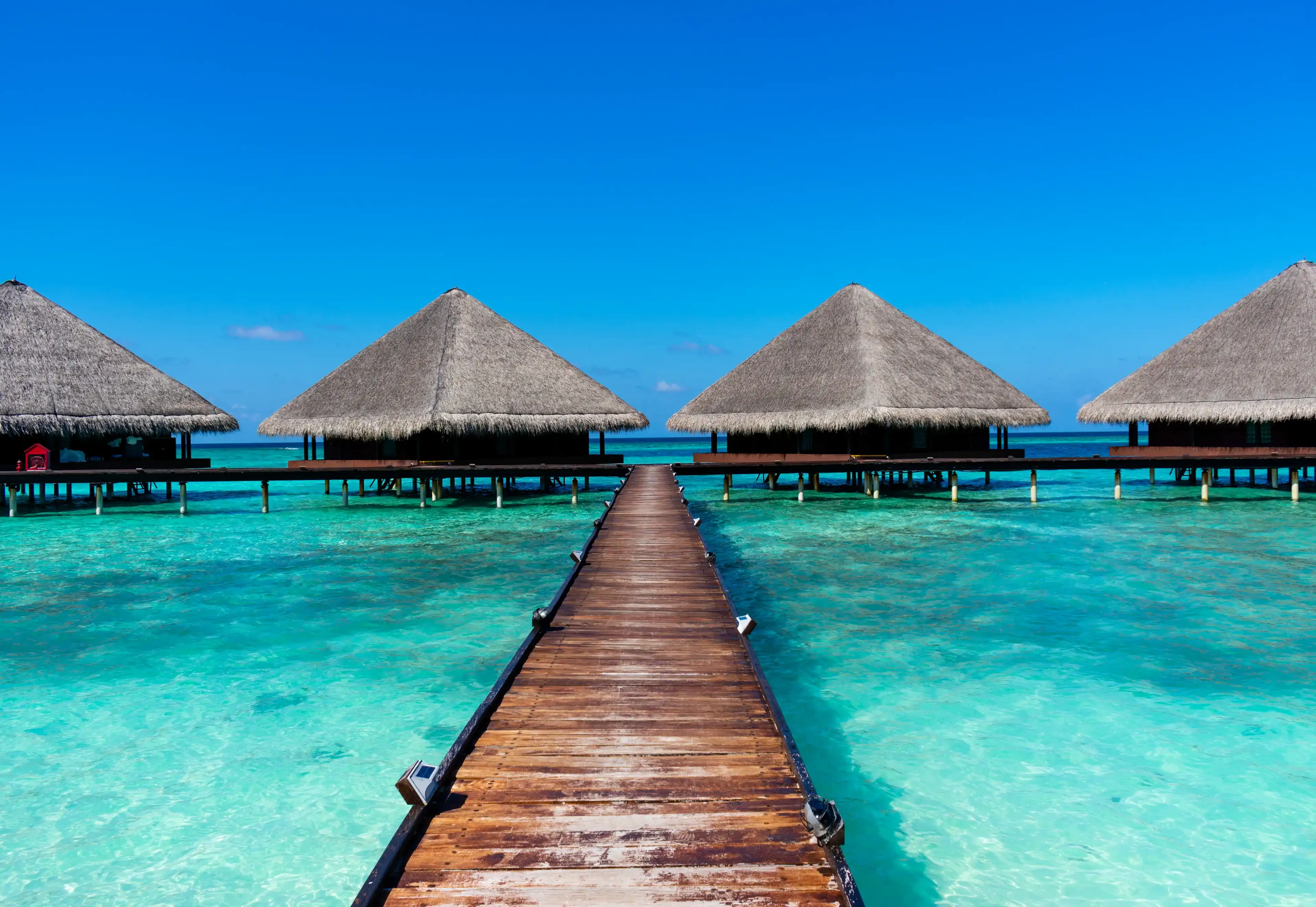 Maldives, Kaafu atoll - December 27 2019 - The wooden pier to the water villas Maldives, Kaafu atoll - December 27 2019 - The wooden pier to the water villas