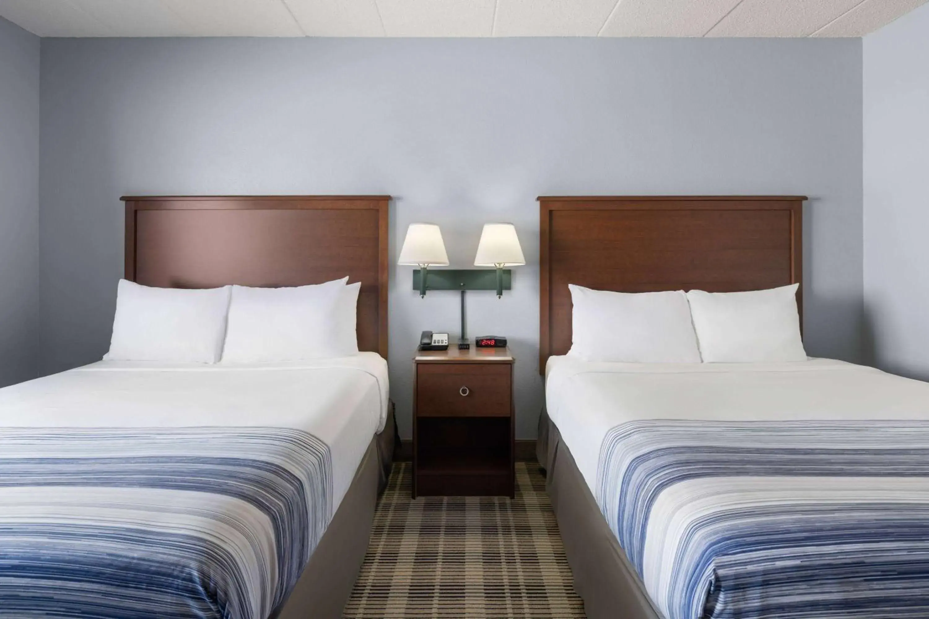 Deluxe Queen Room with Two Queen Beds - Non-Smoking in AmericInn by Wyndham Stuart Deluxe Queen Room with Two Queen Beds - Non-Smoking in AmericInn by Wyndham Stuart