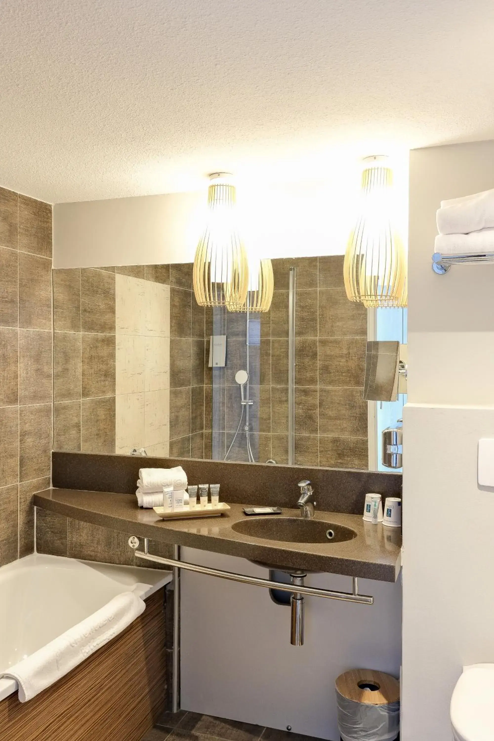 Triple Room with sofa - garden side view in Thalazur Port-Camargue - Hotel & Spa Triple Room with sofa - garden side view in Thalazur Port-Camargue - Hotel & Spa